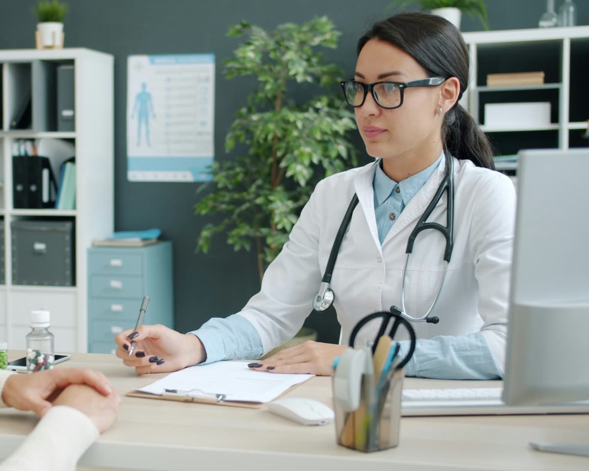 Provider talking with a patient across the desk